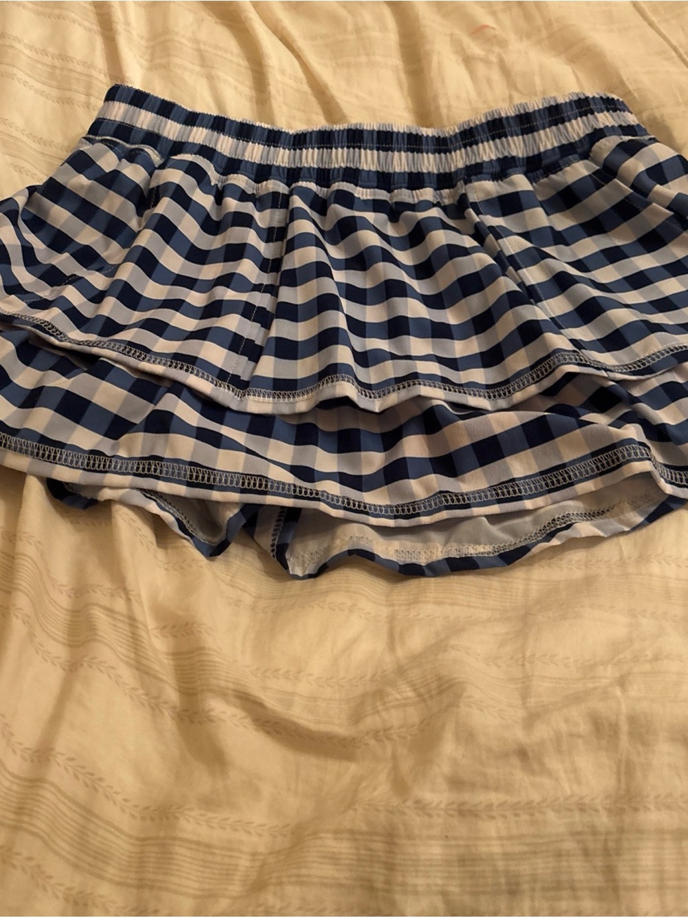 ruffle mini skirt with a blue and white gingham check pattern. The Bubble Size M